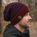 Man wearing a red and blue striped knit beanie outdoors